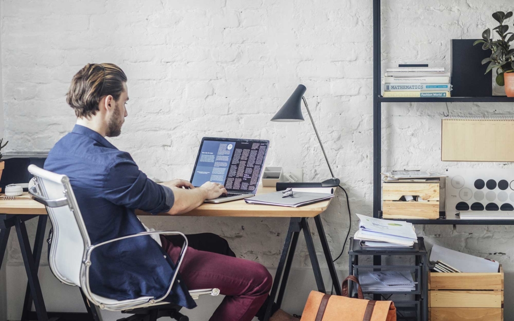 Young-worker-using-laptop-at-home-to-work-remote