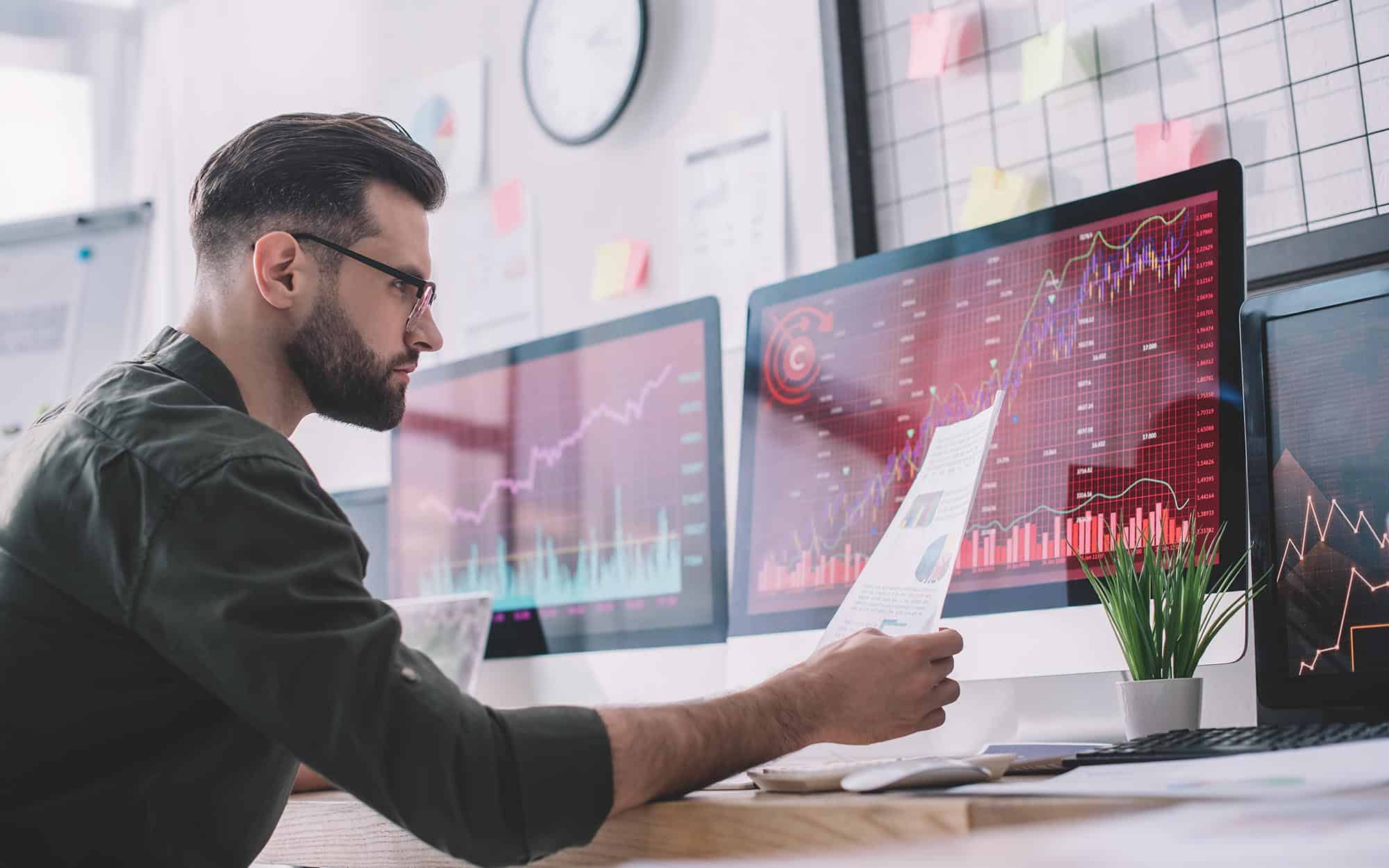 Image of a business person reviewing graphs on their computer.