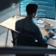 Professional looking at code on computer