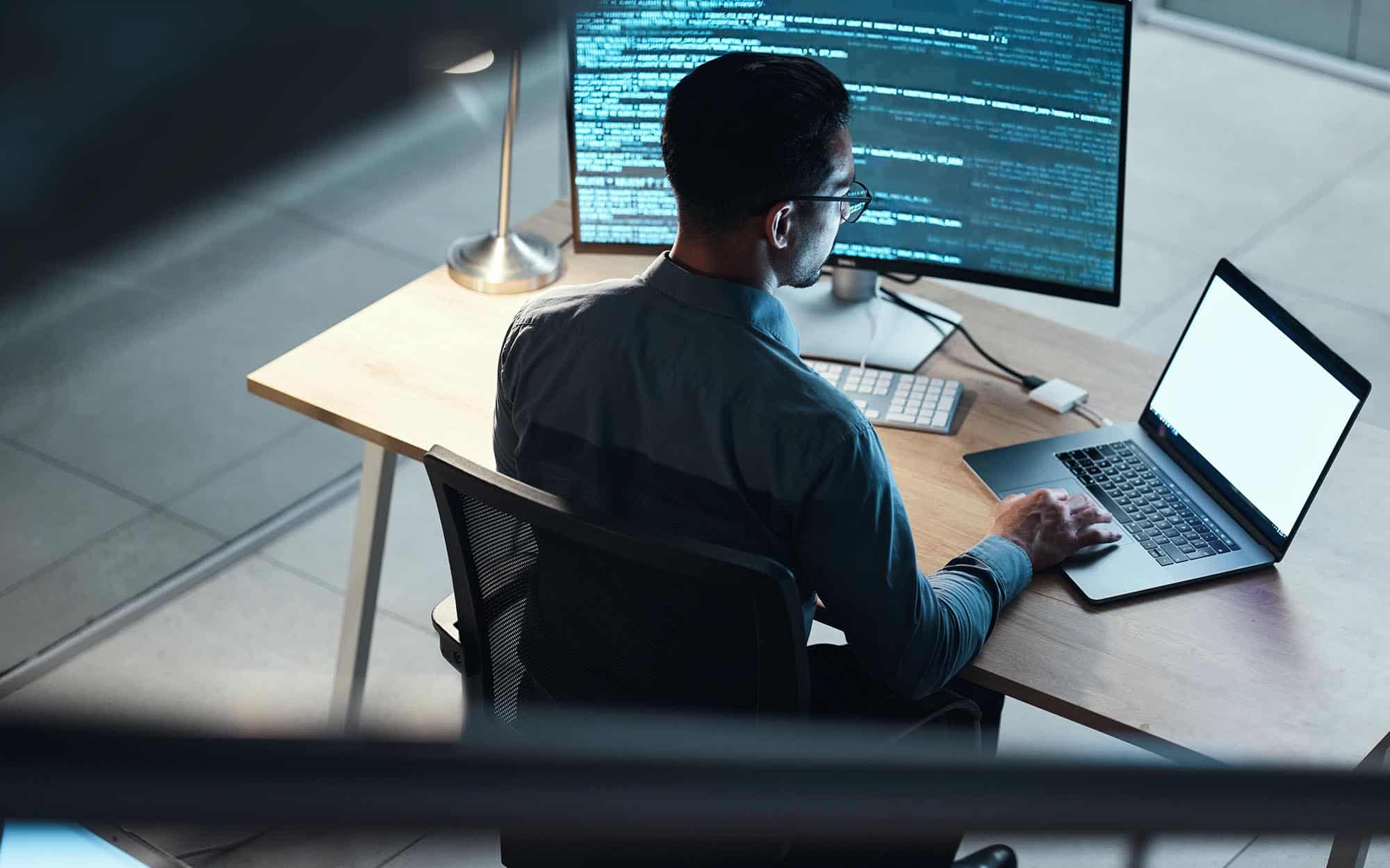 Professional looking at code on computer